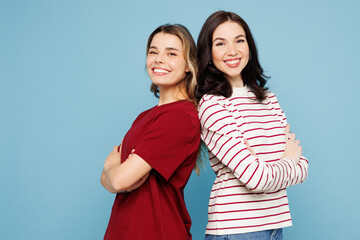 Young happy couple two friends women wear red casual clothes together stand back to back look...