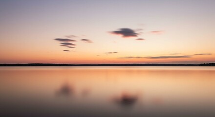 Obraz premium Serene Sunset over Calm Lake Peaceful Evening Sky with Clouds Reflected on Still Water