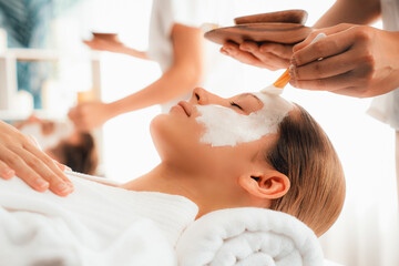 Serene ambiance of spa salon, couple indulges in rejuvenating with luxurious face cream massage with modern daylight. Facial skin treatment and beauty care concept. Quiescent