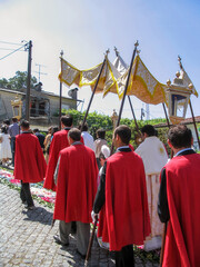 Portugal. First Communion procession. Catholic Priest with Processional Canopy hold by acolytes follows young communicants