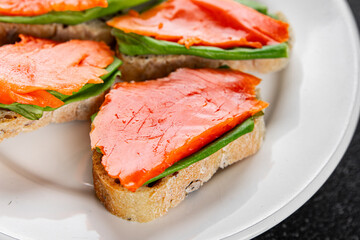 Salmon sandwich red fish seafood appetizer dish fresh tasty gourmet food background on table rustic food top view copy space 