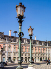Lisbon, Portugal. Restauradores Square. Large 19th Century ornate bronze Streetlamps. Oxidized green. Foz palace in background.