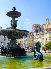 Lisbon, Portugal. Close-up on one of the two bronze fountains with mermaids and water jets. Rossio Square or Dom Pedro IV Square.