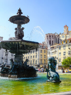 Lisbon, Portugal. Close-up on one of the two bronze fountains with mermaids and water jets. Rossio Square or Dom Pedro IV Square.