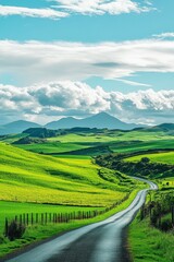 Fototapeta premium Scenic winding road through lush green countryside landscape