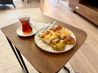 Homemade Turkish pastry with traditional tea on wooden table