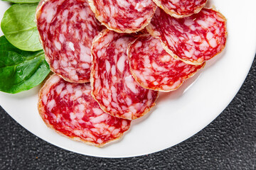Dry-cured sausage salami appetizer dish fresh gourmet food background on the table rustic food top...