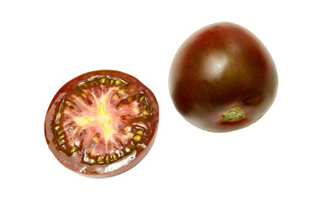 Brown tomato whole and cut in half, on white background. Fresh and ripe. Top view