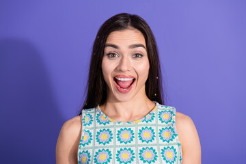 Fototapeta premium Portrait of an Excited Young Woman with Open Mouth Expression Against a Violet Background