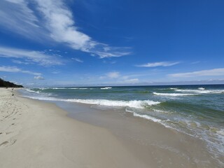 Empty Baltic Shoreline with White Sand Beach Stretching to Horizon Under Spectacular Blue Summer Sky