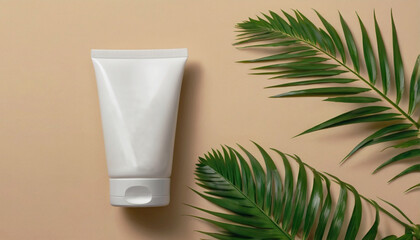 One clean white tube of cream on beige background with green leaves. Cosmetic packaging mockup