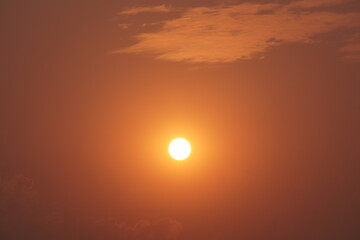 Glowing Sunset with Diffused Sunlight and Vibrant Orange-Red Sky