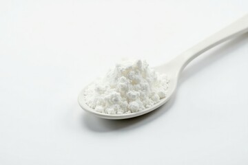 Spoonful of white sugar against white backdrop, unprocessed, still life, photography