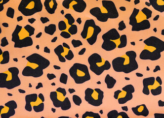 A fun camouflage pattern fabric closeup in peach and black