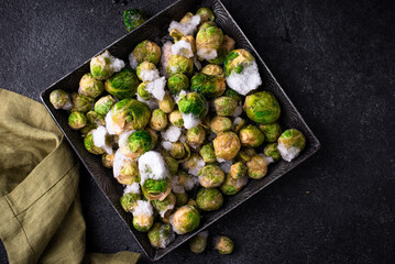 Frozen Brussels sprouts on dark background