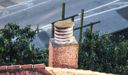 Naklejka premium Brick chimney on the roof of a house