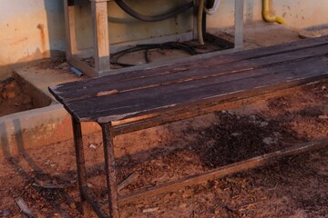 Rustic Wooden Bench in Outdoor Setting with Soft Evening Light