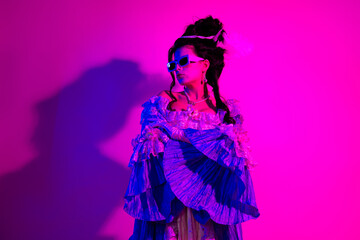 Elegant woman depicted in historical attire with modern accents under vibrant ultraviolet lighting capturing a blend of eras and styles