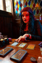Fortune teller reading tarot cards in mystical room