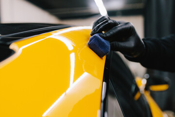Process of applying a ceramic coating to the sports car surface for protection during detailing...