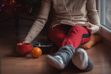 Young woman relaxing indoors in winter