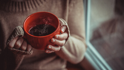 Young woman relaxing indoors in winter