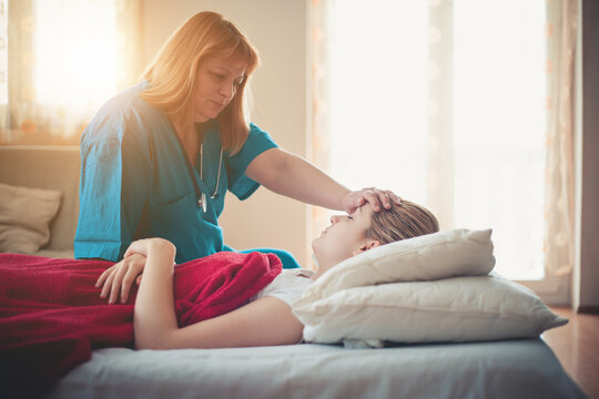 Doctor helping young woman with respiratory problems at home