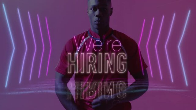 In animation, man wearing red shirt with We're Hiring and pink neon lights