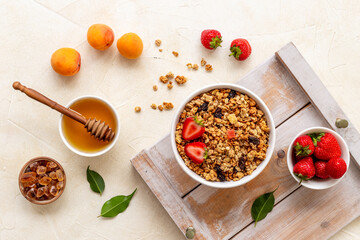 Breakfast with cereal granola honey and strawberry, top view