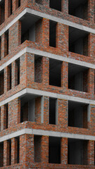 new building with concrete columns and brick walls