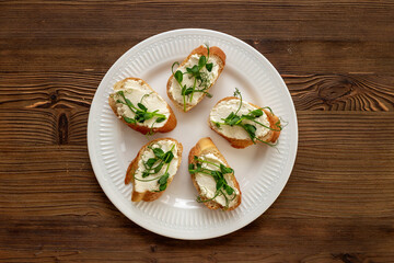 Plate of sandwiches with cream cheese and micro greens peas. Healthy food, top view