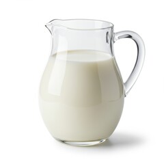 A clear glass pitcher filled with fresh milk on a white background in a studio setting view