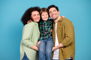 Happy family with mother, father, and son enjoying quality time together against a vibrant blue...