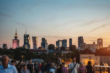 sunset over skyline of Warsaw city with skyscrapers and downtown district, crowd of people walking, tourist travel destination, rush hour in capital of Poland 4k, vertical video footage © goami