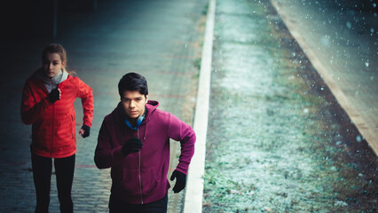 Couple running outdoors in winter