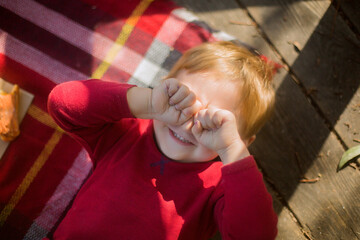 Child Relaxing on a Cozy Picnic Blanket