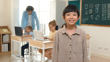 Skilled asian boy looking and waving hands while friend studying about writing engineering code or coding prompt. Professional teacher checking prompt while teaching about AI generated. Pedagogy.