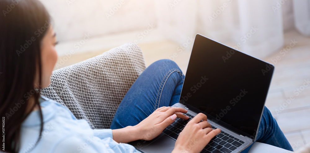 Poster mockup image of asian girl using laptop computer with blank screen at home, space for your design