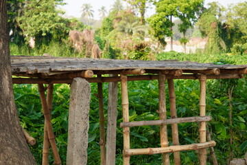A makeshift shelter or shed which appears to be constructed from bamboo and some sort of concrete...