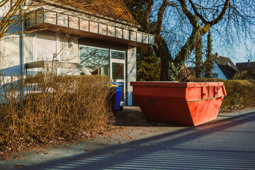 Large metal container for construction waste. Container stands near the house to remove waste after...
