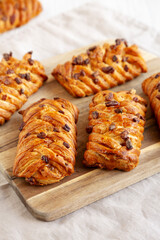 Homemade Maple Pecan Danish Pastry on a wooden board, side view.