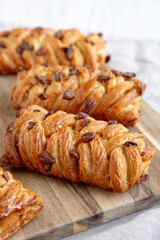 Homemade Maple Pecan Danish Pastry on a wooden board, side view. Close-up.