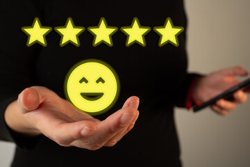 A person holding out their hand with five yellow stars above it, indicating an overall positive...