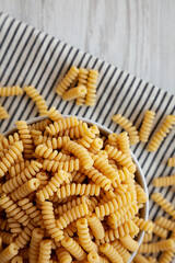 Uncooked Organic Dry Fusilli Pasta in a Bowl, top view. Flat lay, overhead, from above.