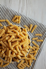 Uncooked Organic Dry Fusilli Pasta in a Bowl, top view. Flat lay, overhead, from above.