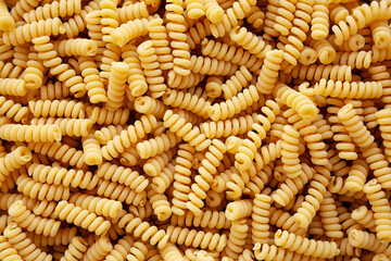 Uncooked Organic Dry Fusilli Pasta, top view. Flat lay, overhead, from above.