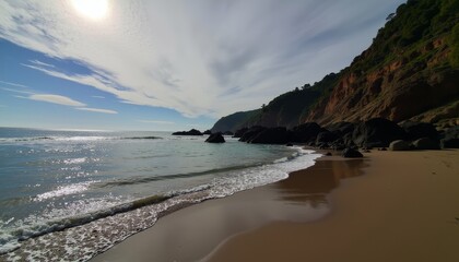 Waves gently lap against the sandy shoreline at a tranquil beach during midday under a bright sun