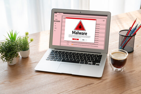 Cyber attacking concept. Malware alert showing on computer screen display scam and threat detection on computer system or online server to be removed snugly.