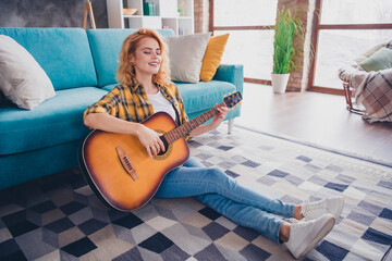 Full length photo of lovely young blonde girl play guitar dressed yellow plaid garment spacious...