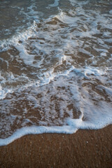 Waves rolling in on the sand 